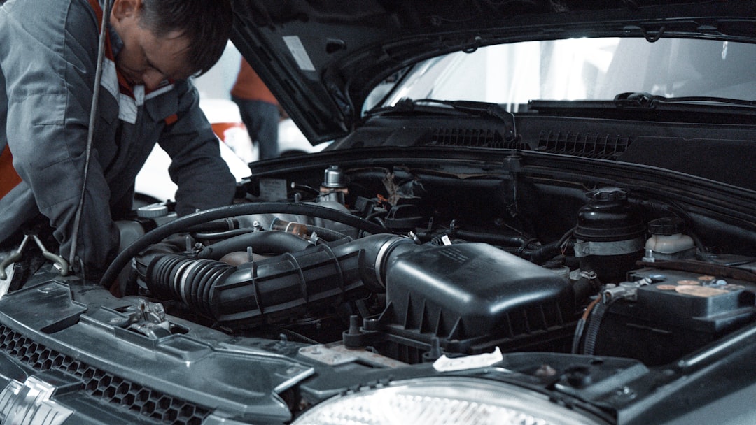 Skilled automotive technician working on professional vehicle installation and technical analysis